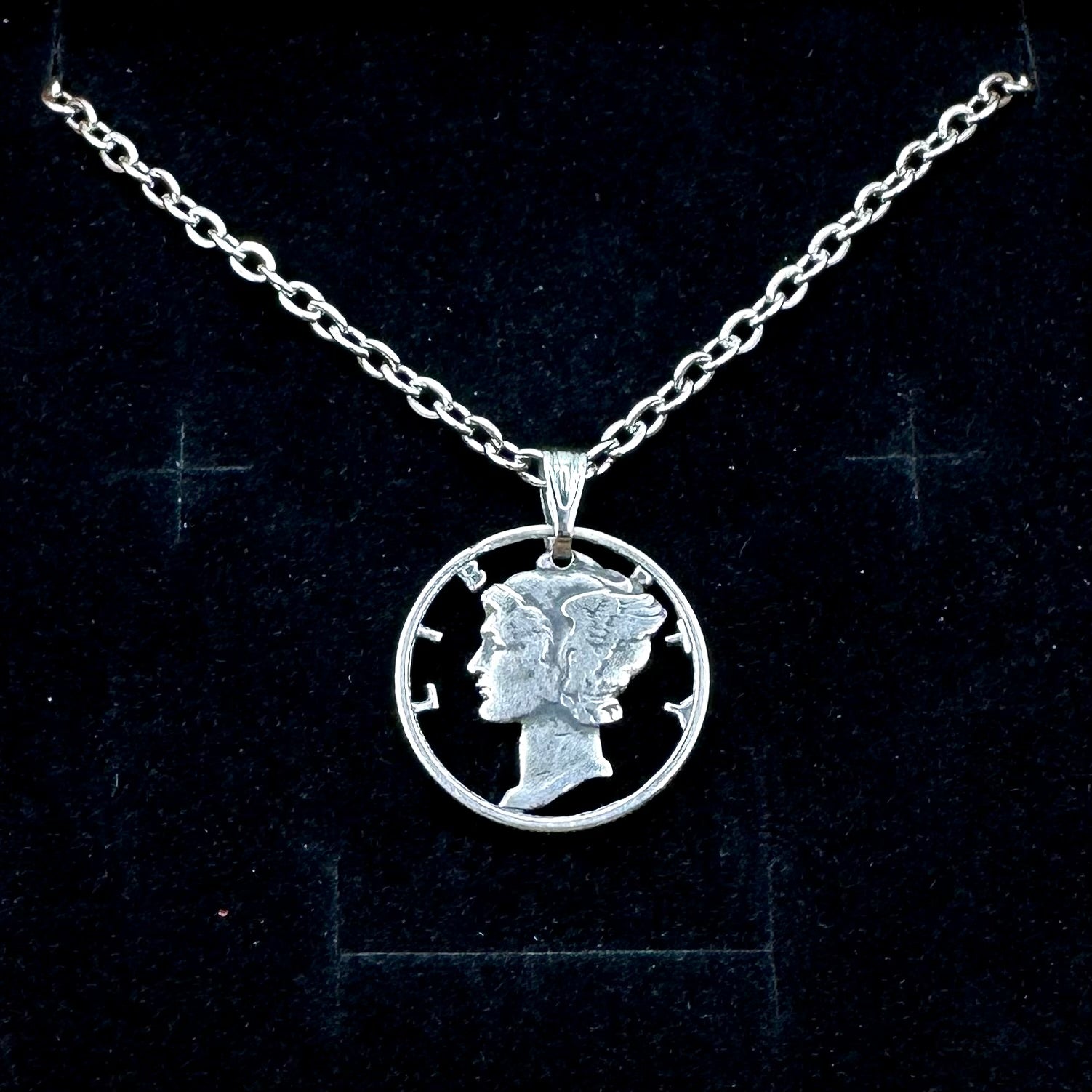 U.S. Mercury Dime Silver Hand Cut Coin Necklace (stainless chain) in a brown kraft box on a black velvet background. - Mountainstruck Coin Jewelry