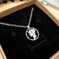 U.S. Mercury Dime Silver Hand Cut Coin Necklace (stainless chain) in a brown kraft box on a black velvet background on top a wood round. - Mountainstruck Coin Jewelry