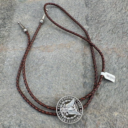 U.S. Morgan Hand Cut Silver Dollar Coin Bolo Tie (reverse) on a grey rock surface. - Mountainstruck Coin Jewelry