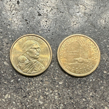 Sacagawea 1 Dollar Coin front on left side of picture and back of coin on right side on a concrete background. - Mountainstruck Coin Jewelry