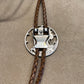 U.S. Silver Eagle Hand Cut Coin Bolo Tie close up on clasp on a light cloth background. - Mountainstruck Coin Jewelry