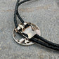 U.S. Silver Eagle Hand Cut Coin Bolo Tie back on a grey rock surface. - Mountainstruck Coin Jewelry