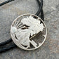 U.S. Silver Eagle Hand Cut Coin Bolo Tie on a grey rock surface. - Mountainstruck Coin Jewelry