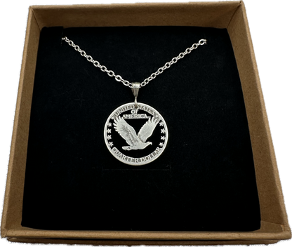 U.S. Soaring Eagle Quarter Hand Cut Silver Coin Necklace on a black velvet background in a brown kraft box. - Mountainstruck Coin Jewelry