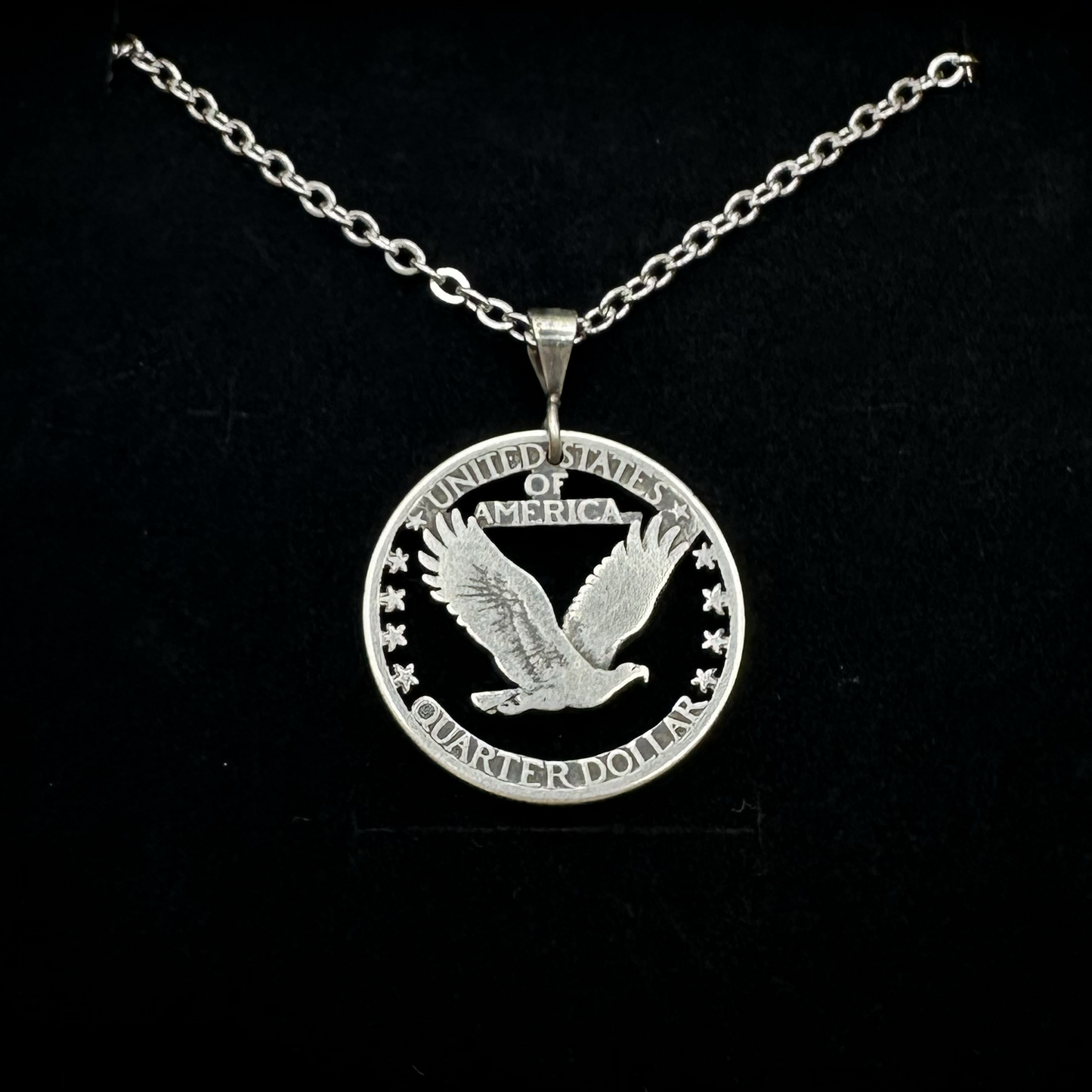 U.S. Soaring Eagle Quarter Hand Cut Silver Coin Necklace on a black velvet background. - Mountainstruck Coin Jewelry