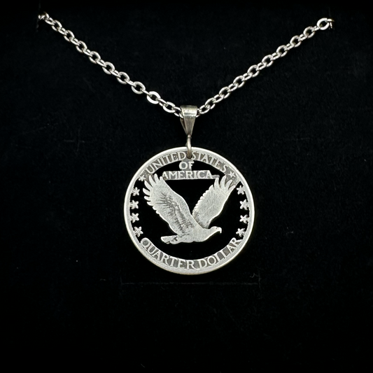 U.S. Soaring Eagle Quarter Hand Cut Silver Coin Necklace on a black velvet background. - Mountainstruck Coin Jewelry