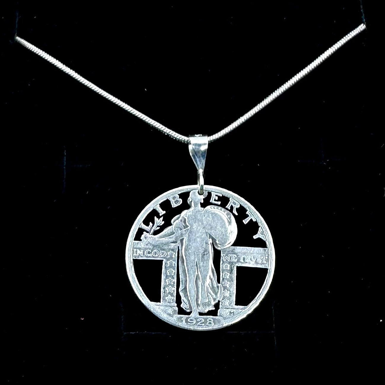 U.S. Standing Liberty Quarter Hand Cut Silver Coin Necklace back on a black velvet background. - Mountainstruck Coin Jewelry