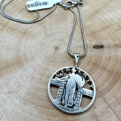 U.S. Standing Liberty Quarter Hand Cut Silver Coin Necklace on a light wood round. - Mountainstruck Coin Jewelry