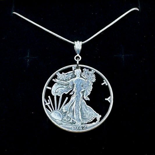 U.S. Walking Liberty Hand Cut Silver Coin Necklace with a snake chain on a black velvet background. - Mountainstruck Coin Jewelry