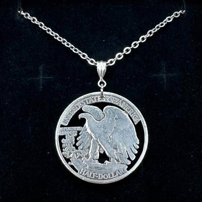 U.S. Walking Liberty Silver Hand Cut Coin Necklace (Eagle) with a stainless chain in a brown kraft box on a black velvet background. - Mountainstruck Coin Jewelry