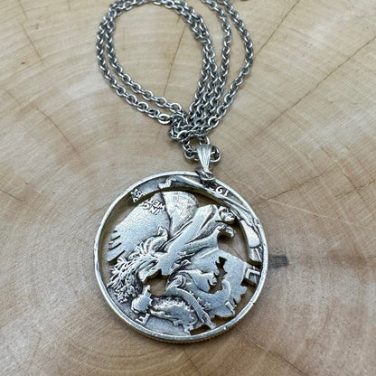 U.S. Walking Liberty Silver Hand Cut Coin Necklace (Eagle) back with a stainless chain on a light wood background. - Mountainstruck Coin Jewelry