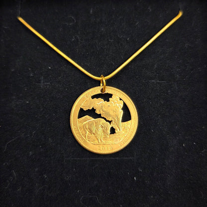 U.S. Yellowstone National Park Quarter Hand Cut Coin Necklace 24k gold plate with snake chain on a black velvet background. - Mountainstruck Coin Jewelry