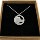 U.S. Yosemite National Park Quarter Hand Cut Coin Necklace with snake chain in a brown kraft box on a black velvet background. - Mountainstruck Coin Jewelry