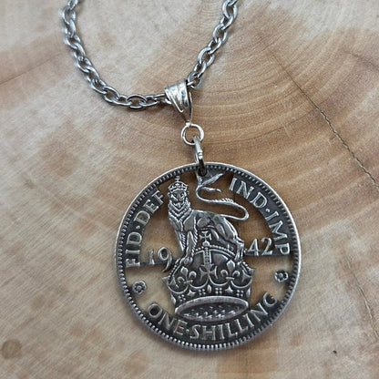 UK One Shilling Hand Cut Silver Coin Necklace with stainless chain on a wood background. - Mountainstruck Coin Jewelry