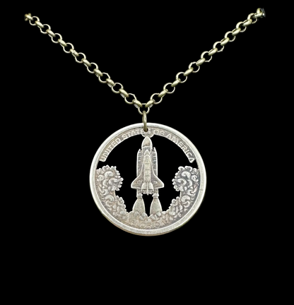 American Innovation $1 Florida Space Shuttle Hand Cut Coin Necklace on a black velvet background. - Mountainstruck Coin Jewelry