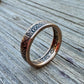 22k U.S. Gold Half Eagle $5 Coin Ring  on its side on a grey wood background. - Mountainstruck Coin Jewelry