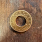 22k U.S. Gold Eagle $10 Coin with hold punched out to make ring on a dark wood table. - Mountainstruck Coin Jewelry