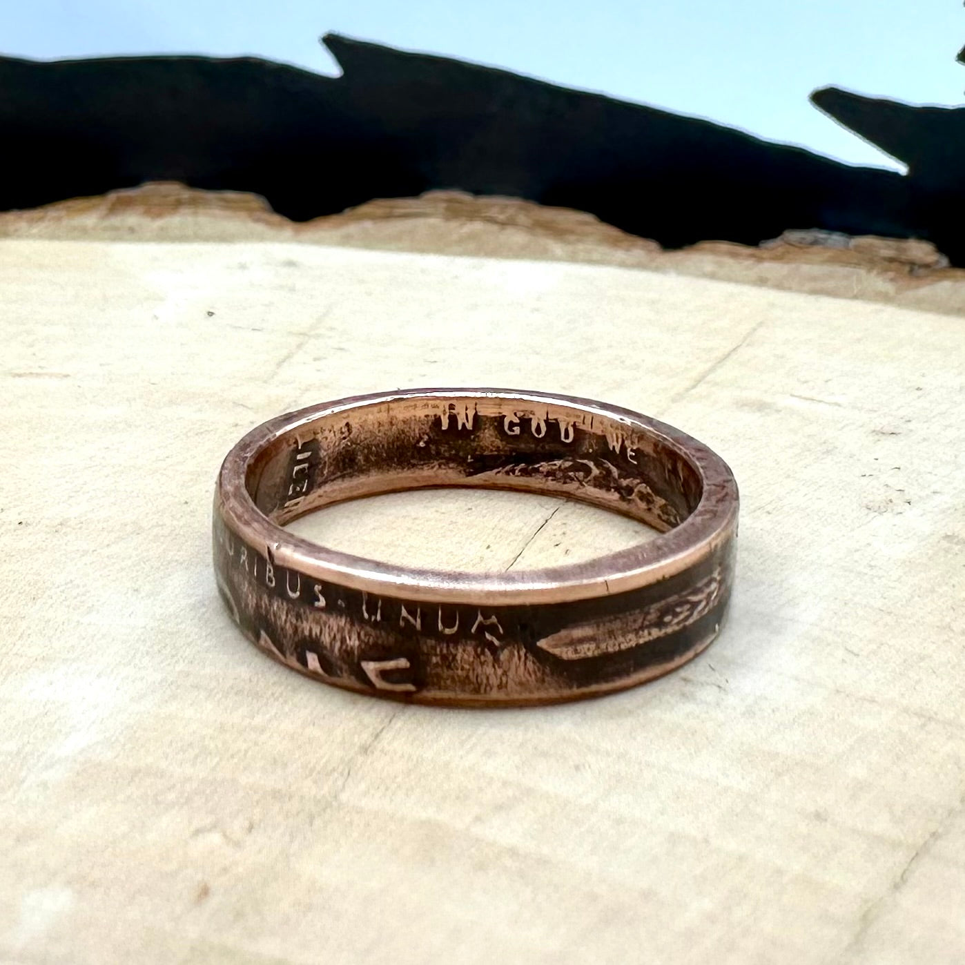 U.S. Wheat Penny Coin Ring on a light wood round. - Mountainstruck Coin Jewelry