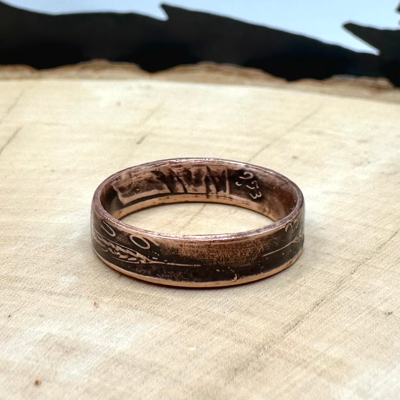 U.S. Wheat Penny Coin Ring on a light wood round. - Mountainstruck Coin Jewelry