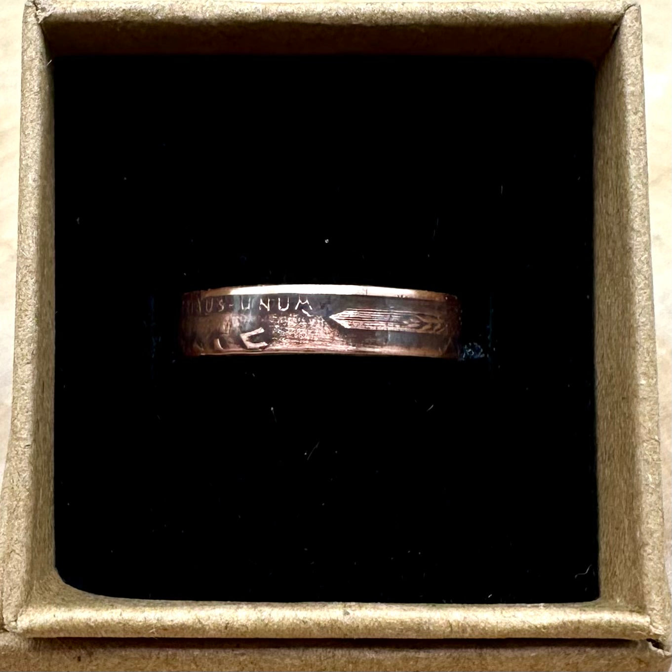 U.S. Wheat Penny Coin Ring in a brown kraft box on a black velvet background. - Mountainstruck Coin Jewelry