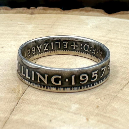 Australia Shilling Silver Coin Ring on light wood round with a metal mountain background. - Mountainstruck Coin Jewelry