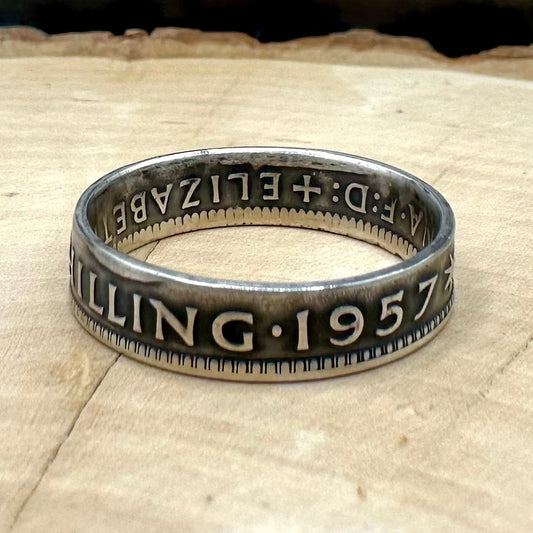 Australia Shilling Silver Coin Ring on light wood round with a metal mountain background. - Mountainstruck Coin Jewelry