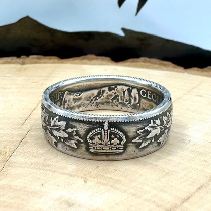 Canada 50 Cents Maple Leaf Silver Ring on a light wood round with a mountain outline background. - Mountainstruck Coin Jewelry