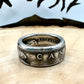 Canada Dollar Silver Coin Ring on a light wood round with a metal mountain background. - Mountainstruck Coin Jewelry