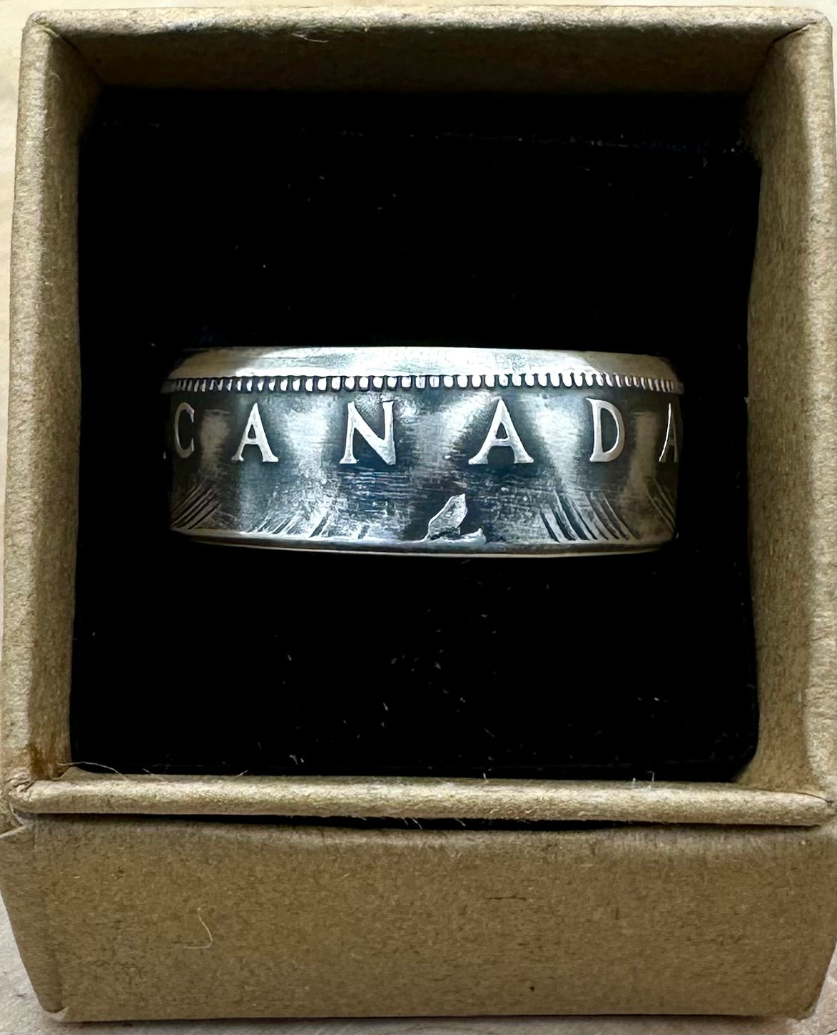 Canada Dollar Silver Coin Ring in a brown kraft box on a black velvet background. - Mountainstruck Coin Jewelry