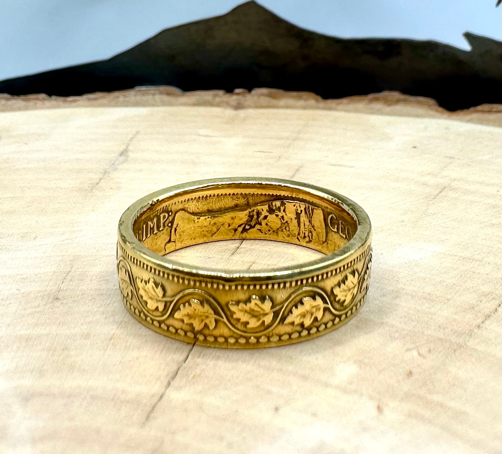 Canada Large Cent Leaf Coin Ring 24k gold plated on a light wood round with a mountain outline background. - Mountainstruck Coin Jewelry