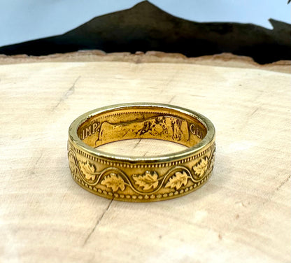 Canada Large Cent Leaf Coin Ring 24k gold plated on a light wood round with a mountain outline background. - Mountainstruck Coin Jewelry