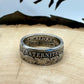 France 2 Franc Silver Coin Ring on a light wood round with a metal mountain background. - Mountainstruck Coin Jewelry