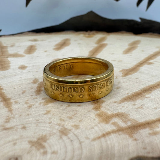 Gold Plated U.S. Presidential Dollar Coin Ring on a wood background. - Mountainstruck Coin Jewelry