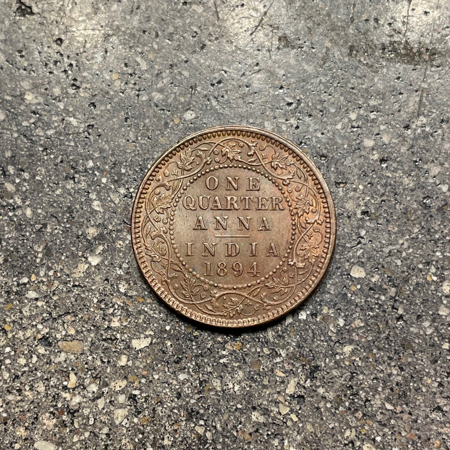 India Quarter Anna Coin back on a concrete background. - Mountainstruck Coin Jewelry