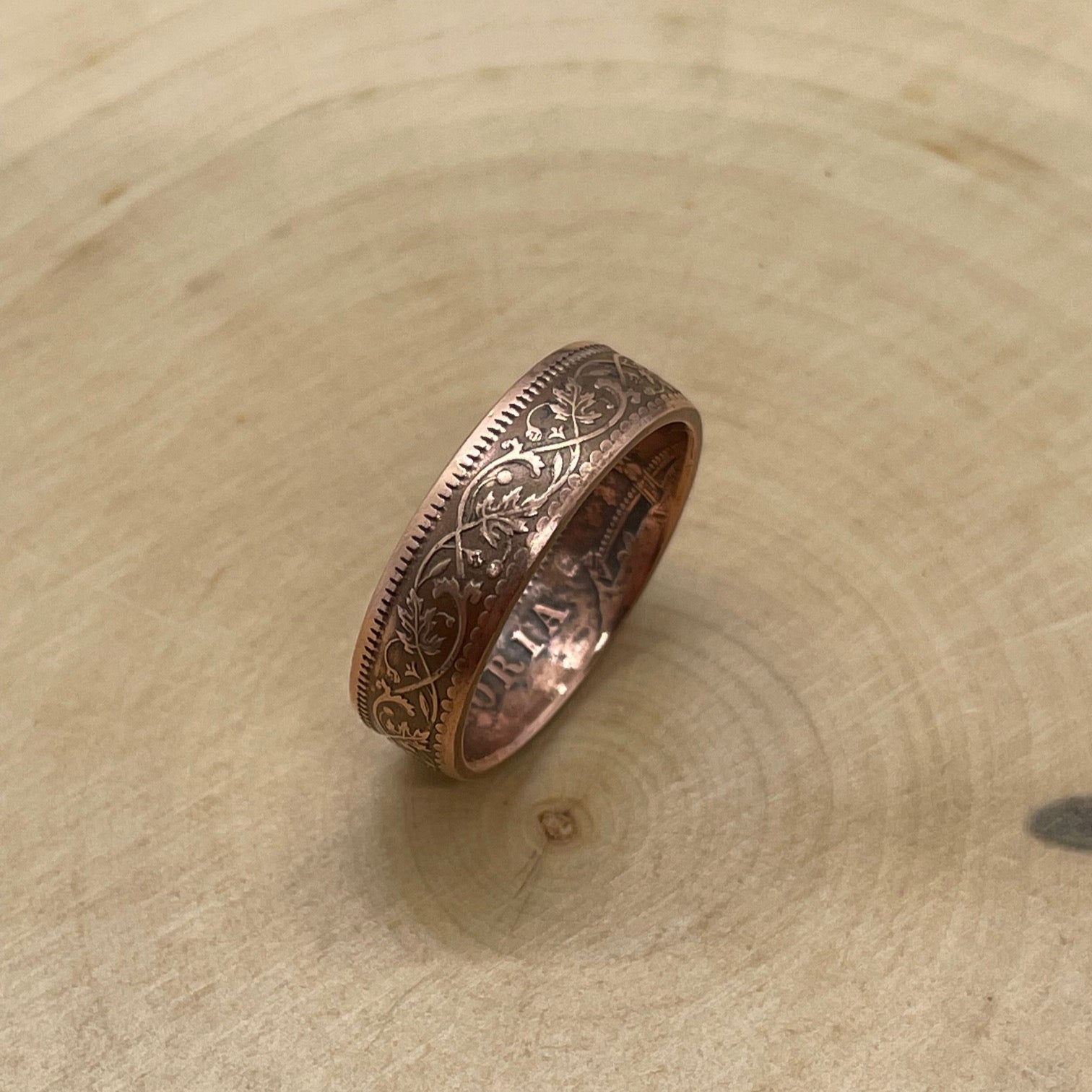 India Quarter Anna Coin Ring on its edge on a light wood round. - Mountainstruck Coin Jewelry