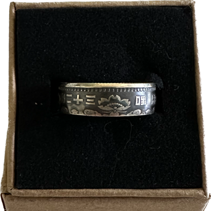 Japan 100 Yen Silver Coin Ring in a brown kraft box on a black velvet background. - Mountainstruck Coin Jewelry