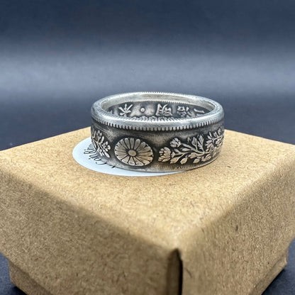 Japan 50 Sen Silver Coin Ring on a brown kraft box. - Mountainstruck Coin Jewelry