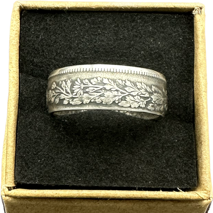 Japan 50 Sen Silver Coin Ring in a brown kraft box on a black velvet background. - Mountainstruck Coin Jewelry