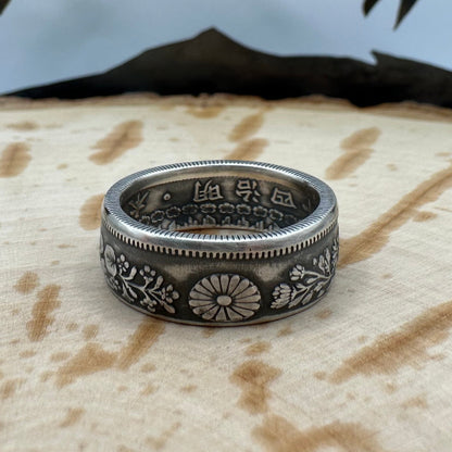 Japan 50 Sen Silver Coin Ring on a wood background. - Mountainstruck Coin Jewelry