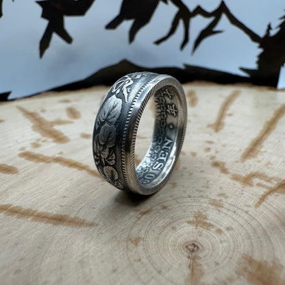 Japan 50 Sen Silver Coin Ring on a wood background. - Mountainstruck Coin Jewelry