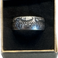 JFK Silver Half Dollar Coin Ring (reverse) in a brown kraft box on a black velvet background. - Mountainstruck Coin Jewelry