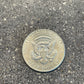 JFK Silver Half Dollar Coin (reverse) on a concrete background - Mountainstruck Coin Jewelry