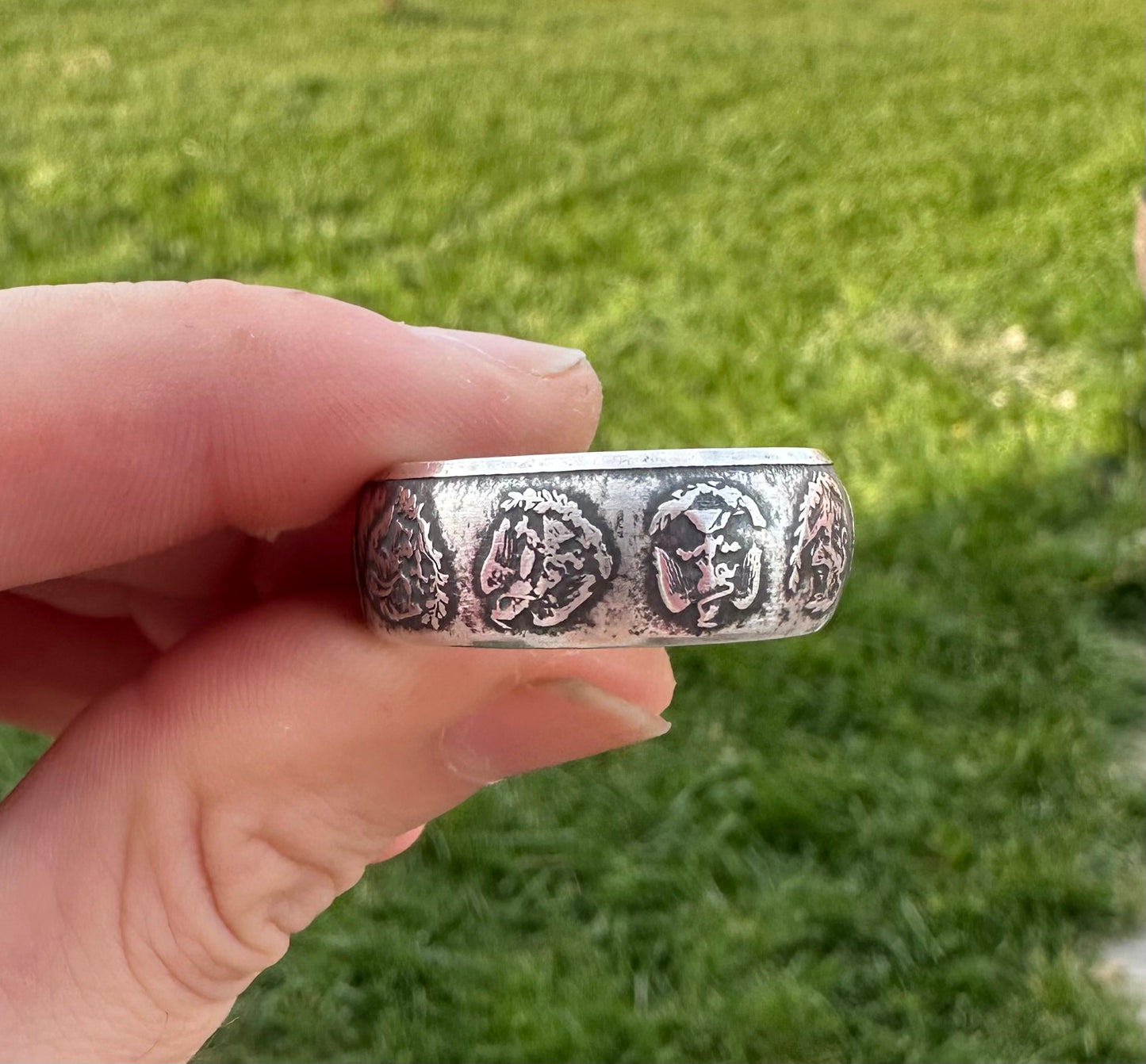 Mexico 1oz Libertad .999 Silver Coin Ring held in front of green grass. - Mountainstruck Coin Jewelry