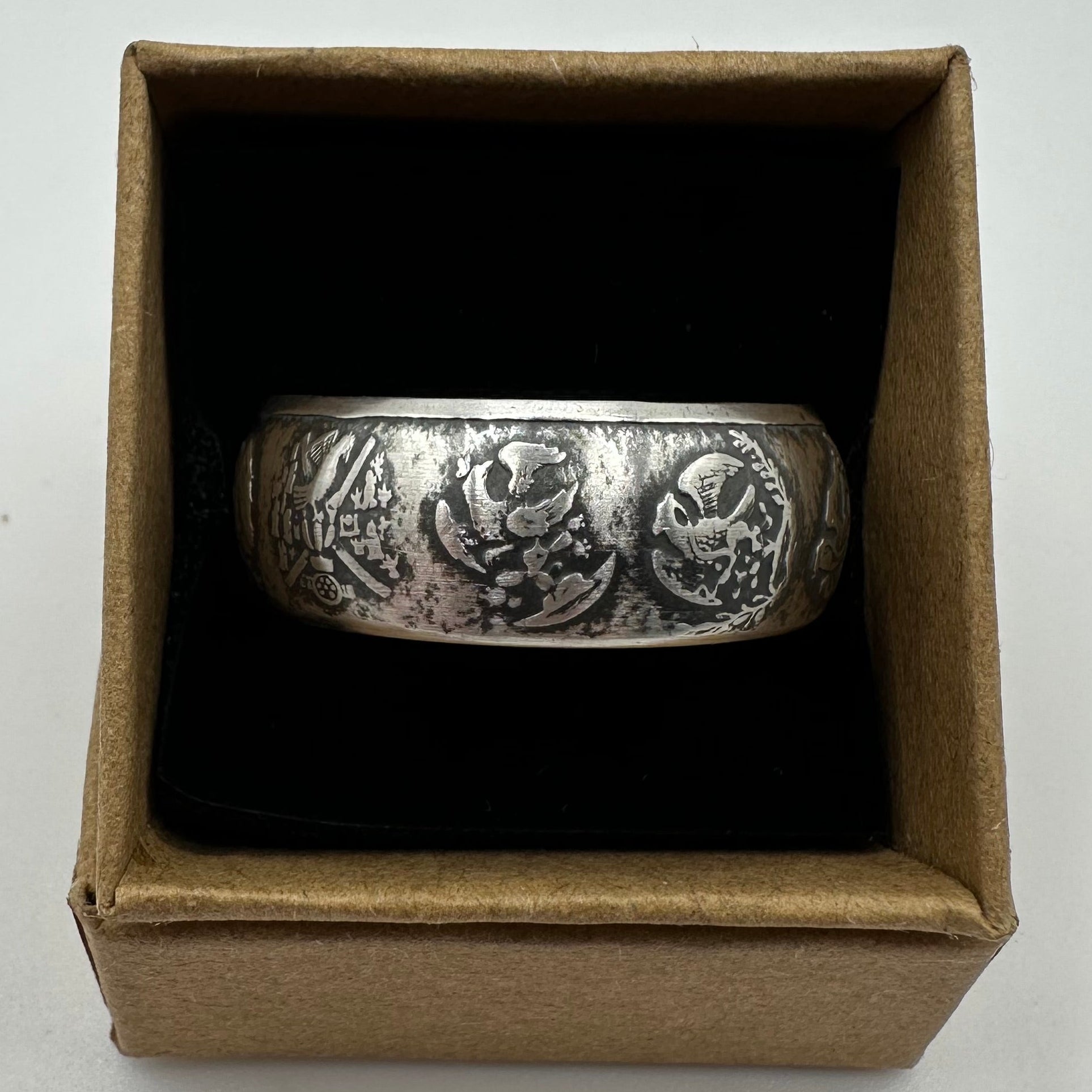 Mexico 1oz Libertad .999 Silver Coin Ring in a brown kraft box on a black velvet background. - Mountainstruck Coin Jewelry