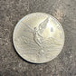 Mexico 1oz Libertad .999 Silver Coin front on a concrete background. - Mountainstruck Coin Jewelry