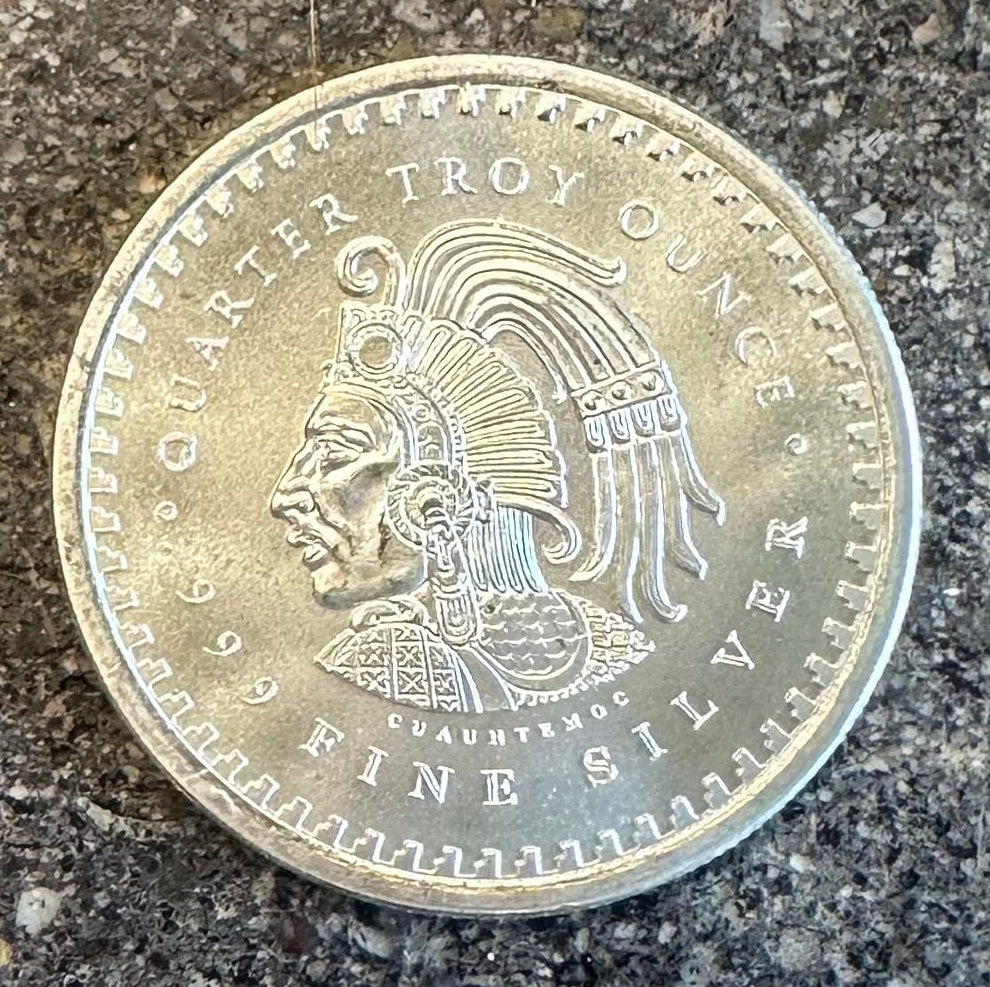 Mexico Aztec Calendar 1/4 oz Silver Round (front) on a dark concrete background. 
- Mountainstruck Coin Jewelry