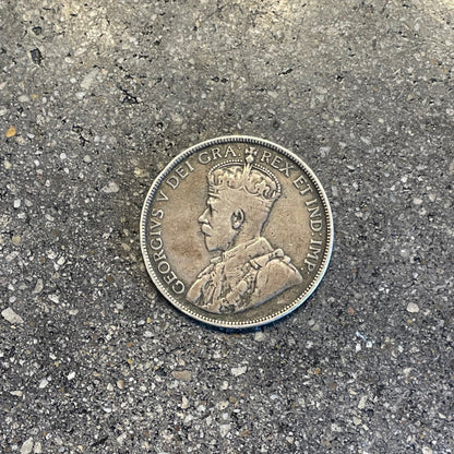 Newfoundland 50 Cents Silver Coin front on a concrete background. - Mountainstruck Coin Jewelry
