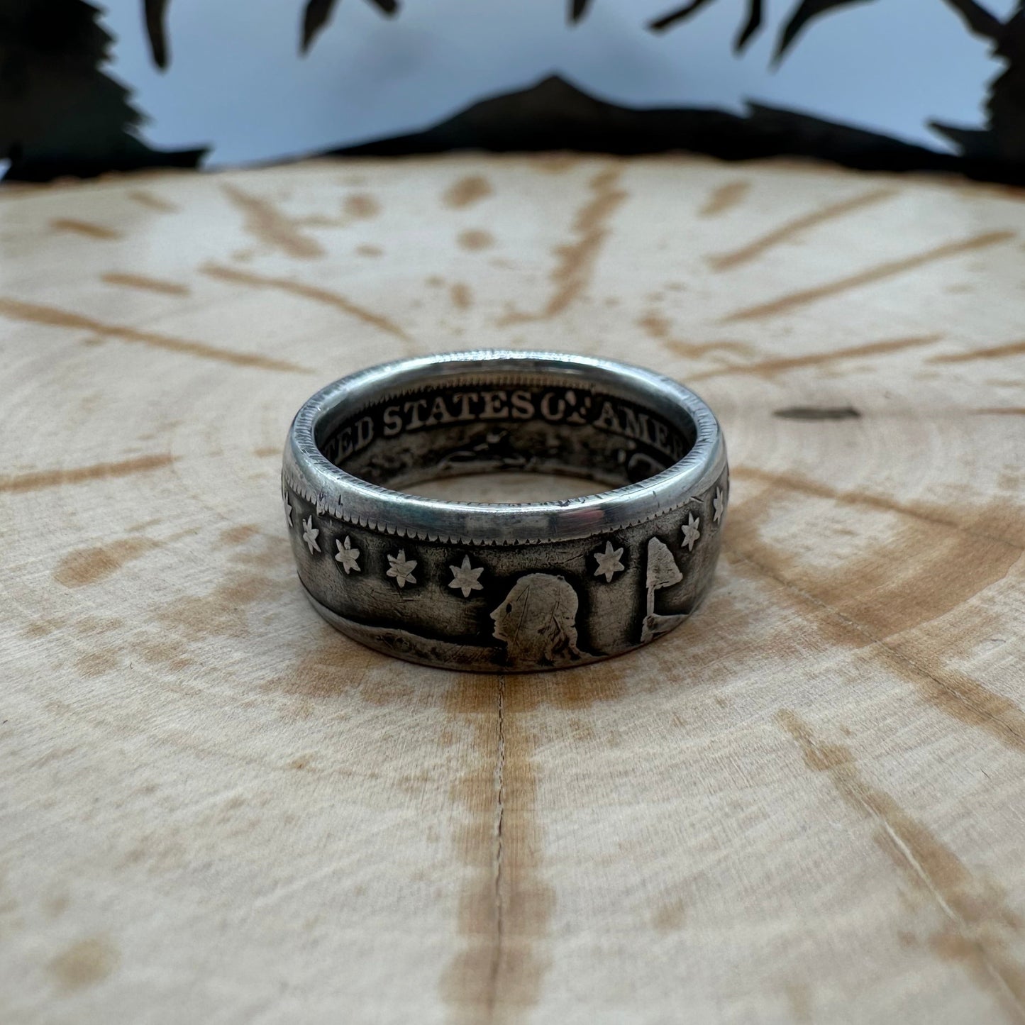 Seated Liberty Silver Half Dollar Coin Ring (patina) on a wood background. - Mountainstruck Coin Jewelry