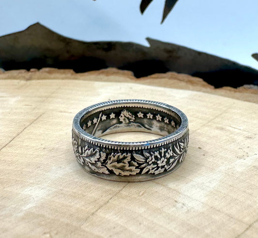 Swiss 1 Franc Silver Coin Ring patina on a light wood round. - Mountainstruck Coin Jewelry