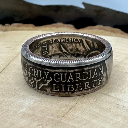 U.S. 2026 Half Dollar Coin Ring on a light wood round with a metal mountain background. - Mountainstruck Coin Jewelry